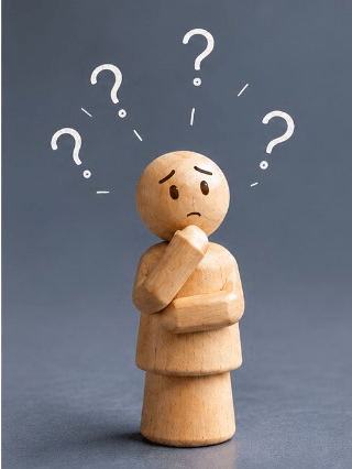A worried wooden figure with question marks above its head